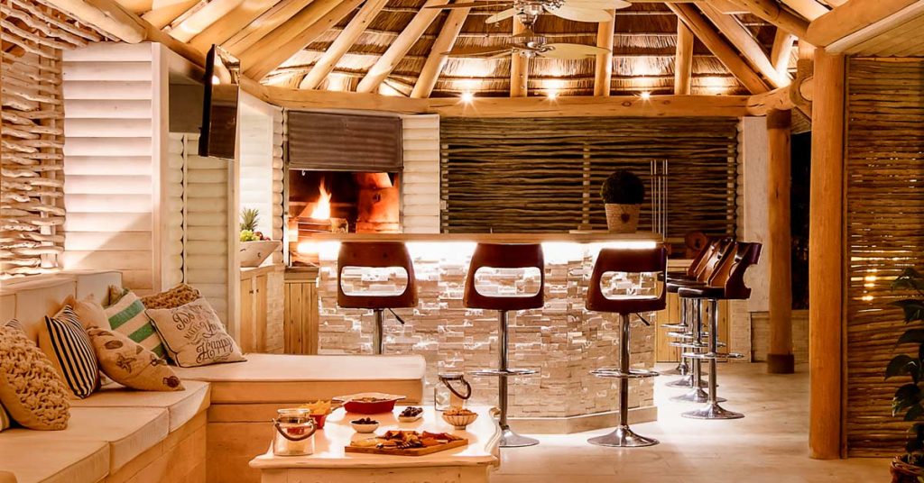 Thatched roof entertainment area with a built in fireplace