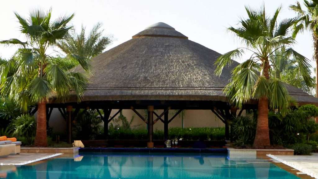 Sunken thatched gazebo with outdoor area