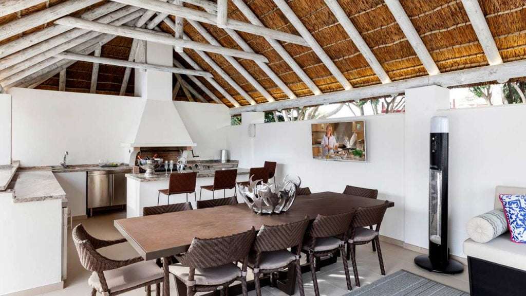Poolside thatched gazebo interior in a whitewash finish