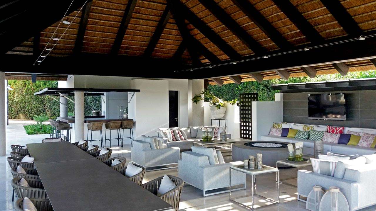 Thatched outdoor living space on square timber with kitchen facilities