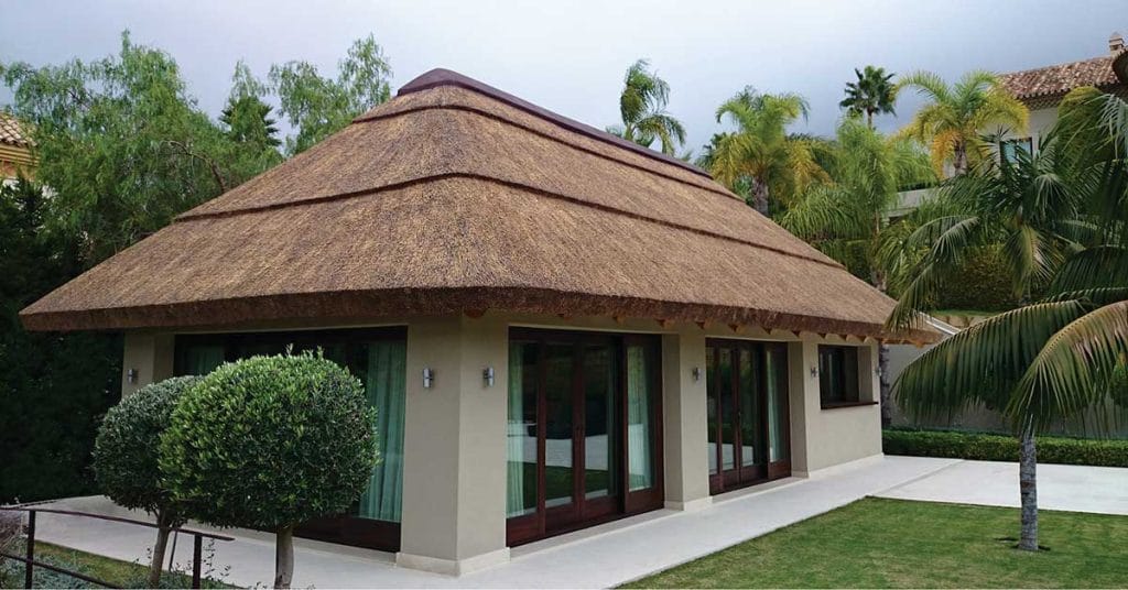 Brick wall enclosure with glass doors and windows