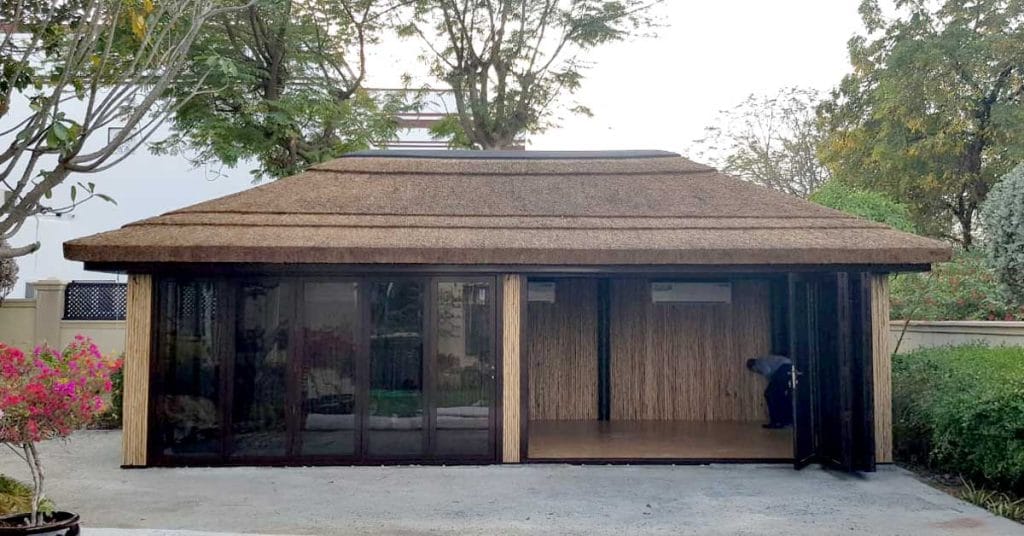Glass and lath combination with thatched roof