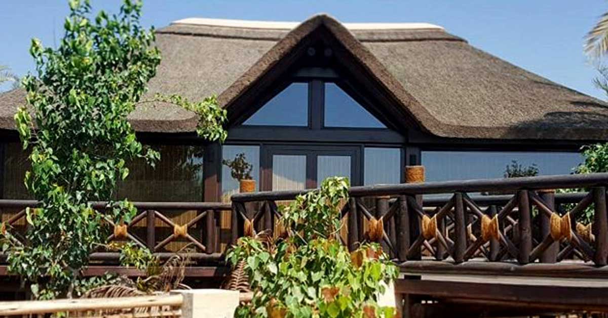 Glass cladding with gabled roof, timber decking and balustrades