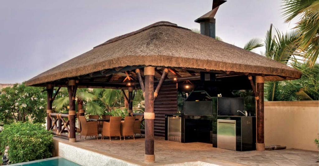 Thatched gazebo with timber cladding, buildt in braai and seating area