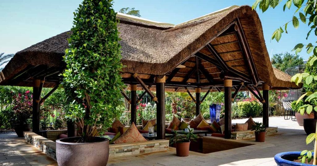 Spectacular outdoor transformation thatched gazebo with gable entrance and sunken seating area