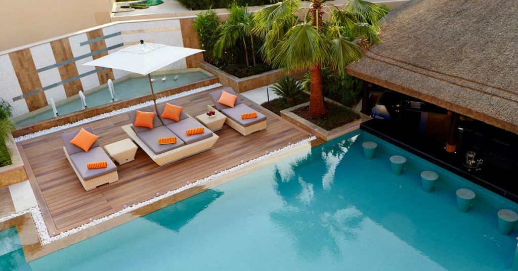 Cape reed poolside thatched gazebo with timber decking and swim-up poolbar