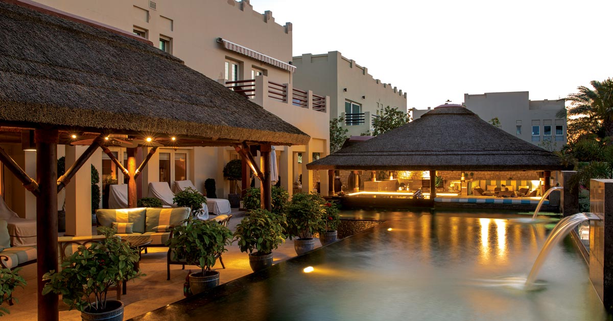 Thatched roof poolside with seating areas