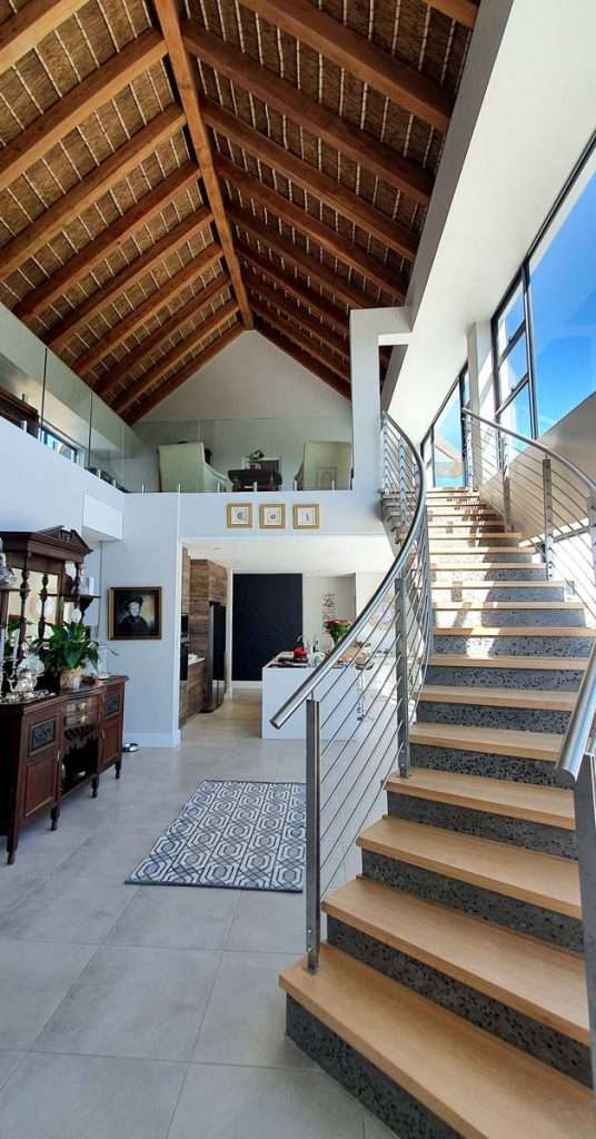 Cape Reed turnkey project residential thatched roof interior with square beams