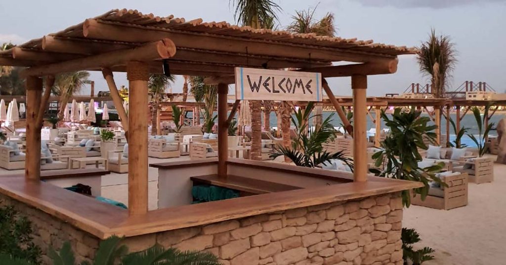 White Beach welcome desk with timber counter and pergola