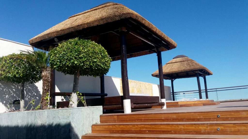 Penthouse thatched daybed cabanas and timber decking