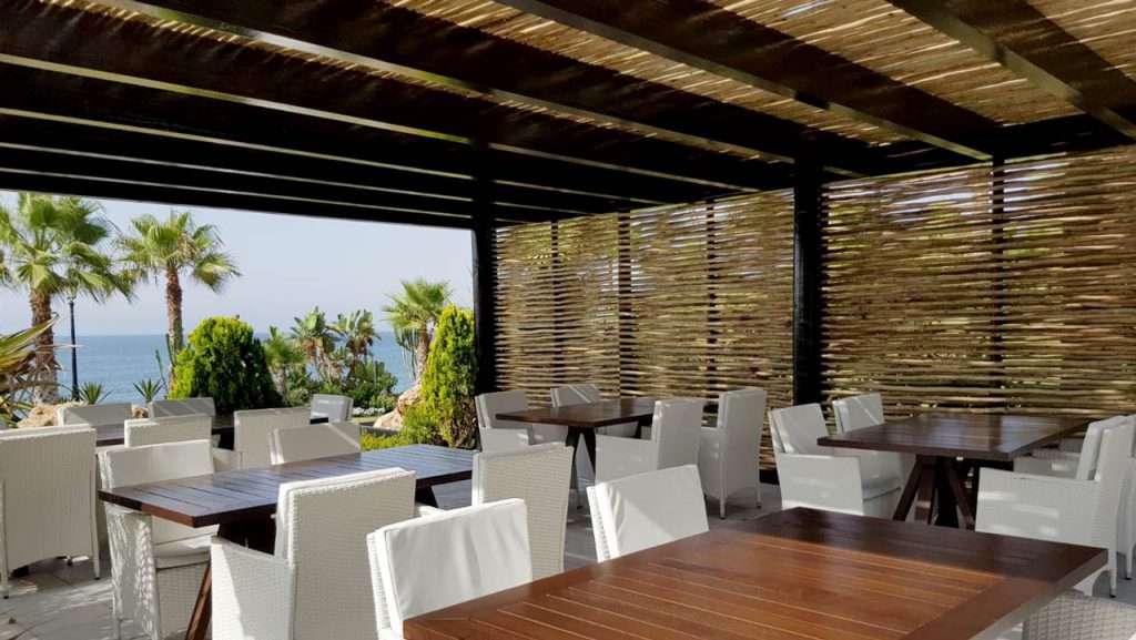 Las Dunas Park semi-shaded timber pergola seating area with woven lath screen