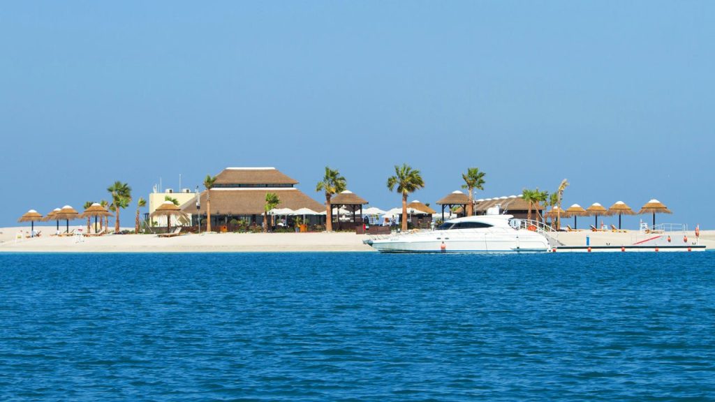 Royal World Island Beach Club in Dubai, showcasing its luxurious beachfront facilities and stunning architecture