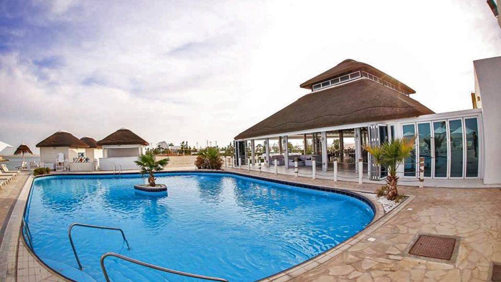 Royal World Island Beach Club in Dubai, showcasing its luxurious beachfront facilities and stunning architecture