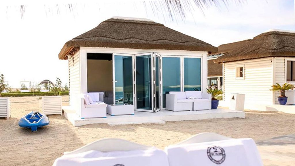 Royal World Island Beach Club in Dubai, showcasing its luxurious beachfront facilities and stunning architecture