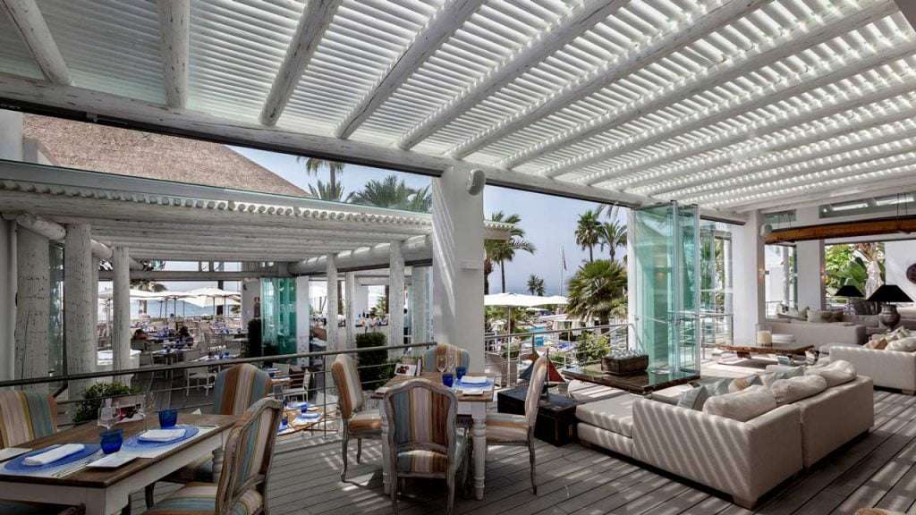 Thatched roof and white washed timber pergola