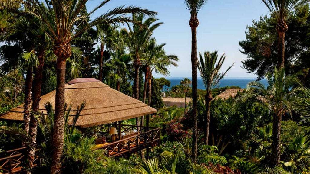 Cape Reed elevated thatched gazebo with timber decking and balustrades. The perfect combination of hard and soft landscaping.
