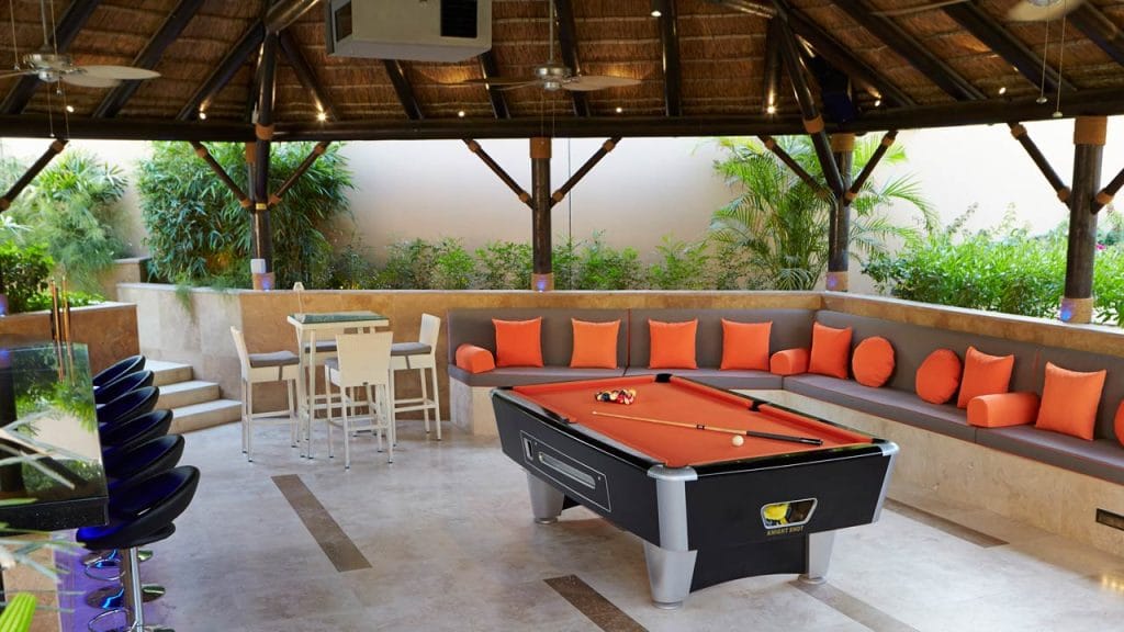 Poolside sunken thatched outdoor living space