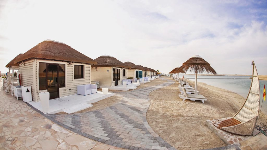 Royal World Island Beach Club in Dubai, showcasing its luxurious beachfront facilities and stunning architecture