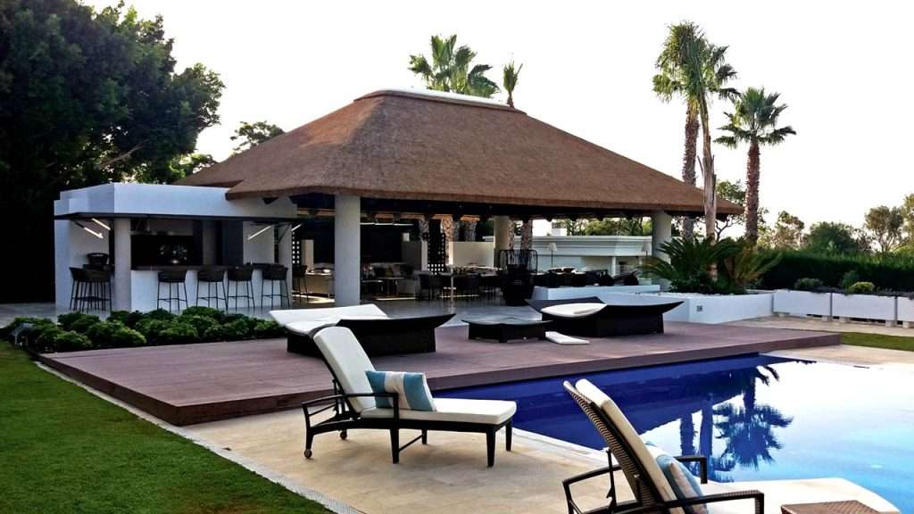 Cape Reed thatched roof outdoor entertainment area on concrete columns in Sotogrande