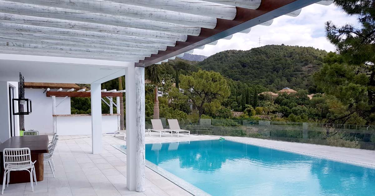 Poolside veranda with white washed timber beams