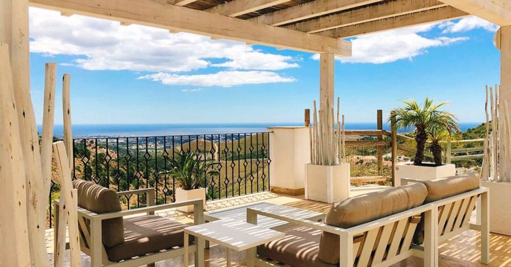 Sun splashed terrace of dreams with square timber pergola
