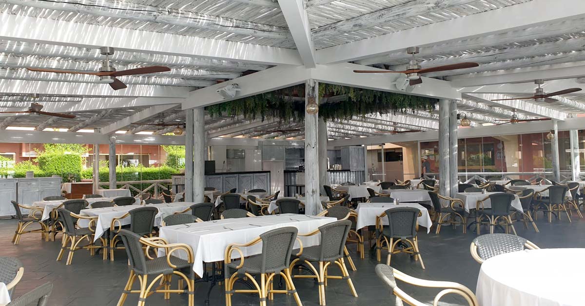The terrace with a whitewash timber pergola at Sunset Beach Club