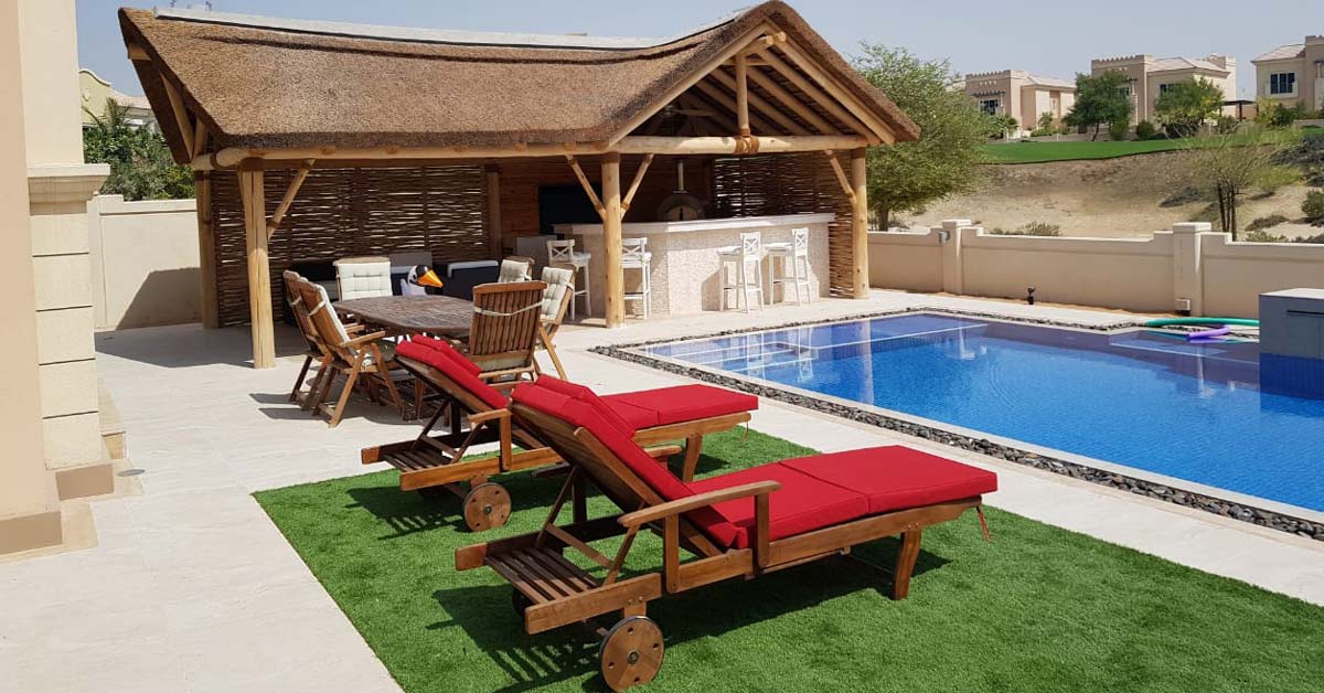 Cape Reed sunlounger by the poolside under a blue sky.