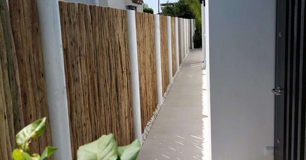 Timber lath fencing with a whitewash finish