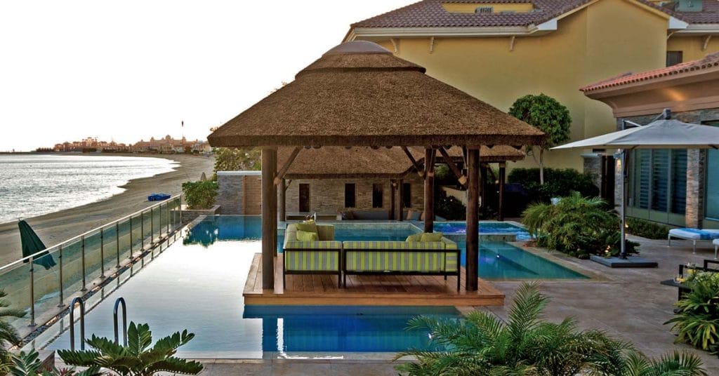 Poolside thatched cabana with seating area