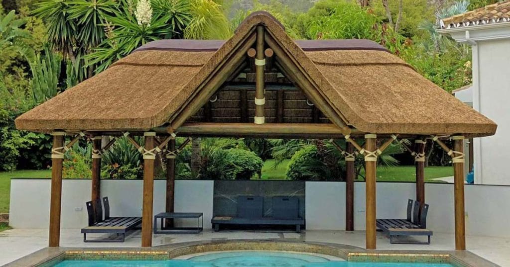 Poolside thatched gazebo with a gabled entrance 