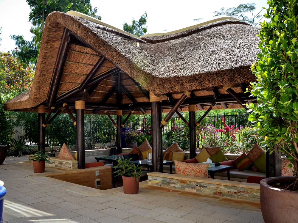 Cape Reed thatched gazebo with a gabled entrance to a sunken seating area in Dubai.
