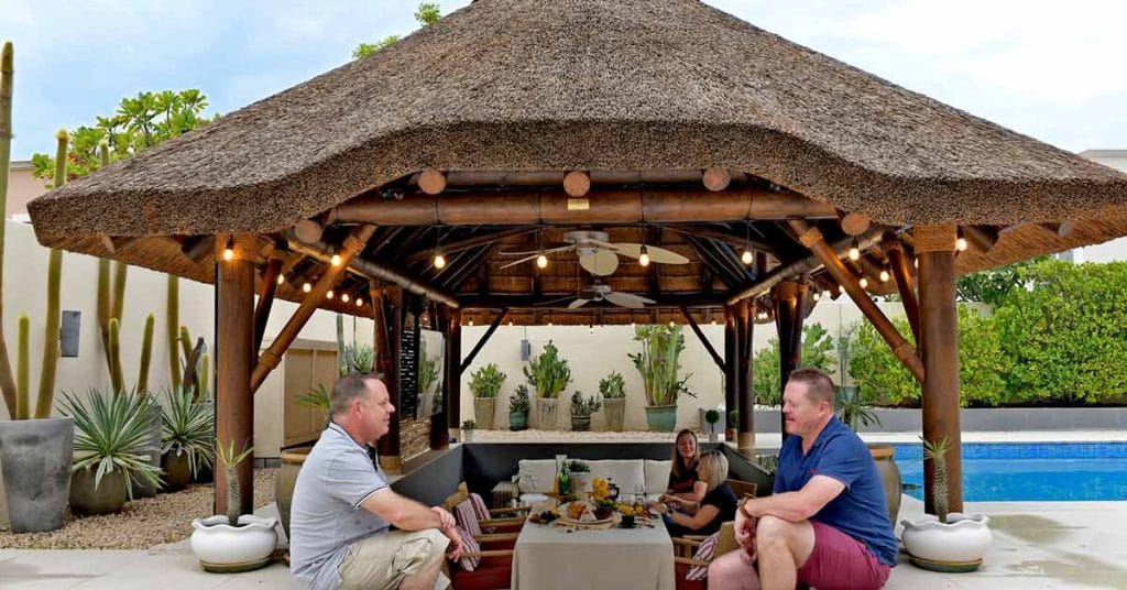 A beautifully crafted thatched gazebo by Cape Reed stands as a luxurious retreat in the serene surroundings of Arabian Ranches, Dubai.