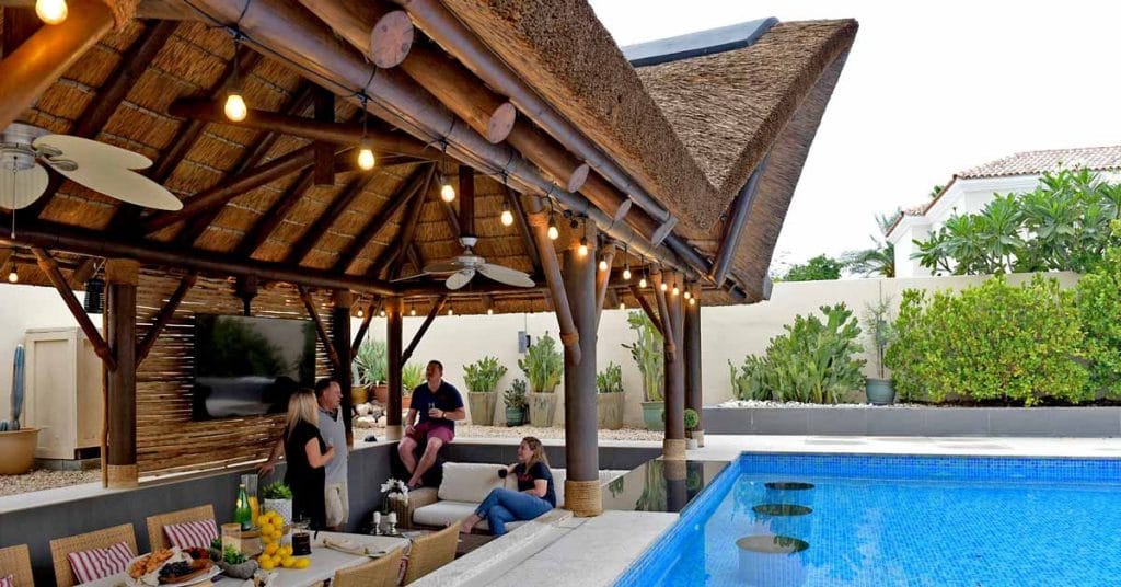 A beautifully crafted thatched gazebo by Cape Reed stands as a luxurious retreat in the serene surroundings of Arabian Ranches, Dubai.
