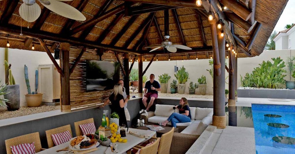Luxurious thatched gazebo in Arabian Ranches, Dubai, surrounded by lush greenery.