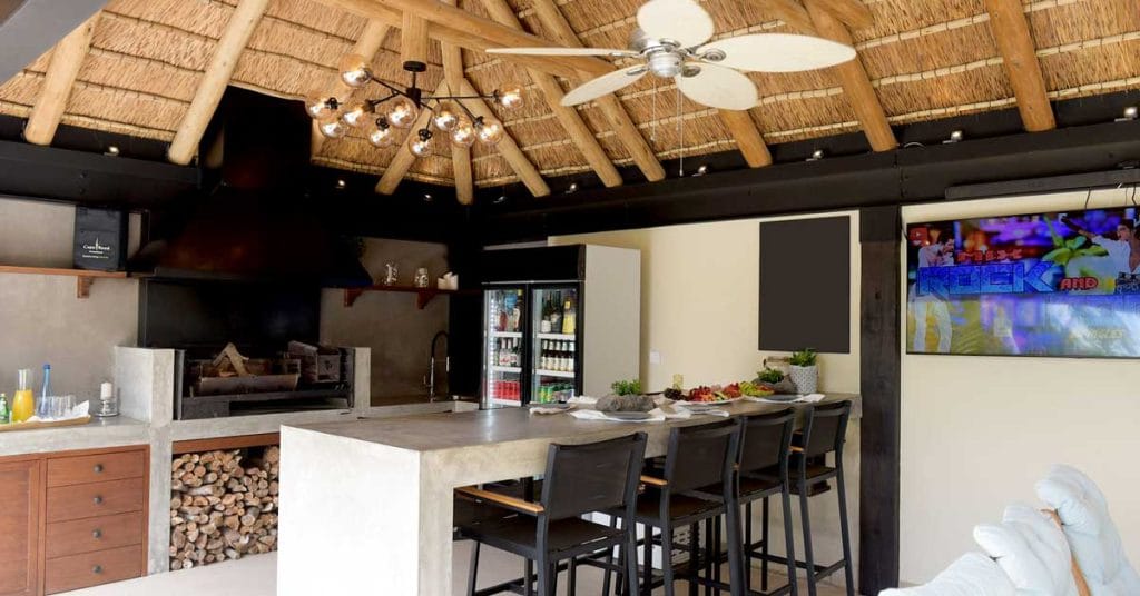 A charming thatched outdoor living room designed for comfort and style, ideal for relaxation and entertaining guests.