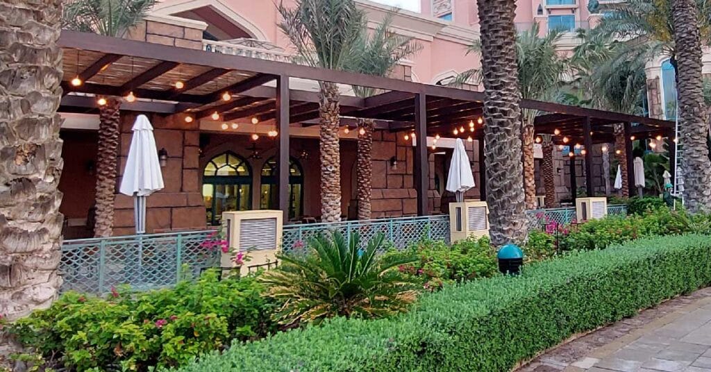 Saffron Terrace’s luxurious buffet dining area shaded by a Cape Reed lath pergola, offering a perfect blend of comfort and style.