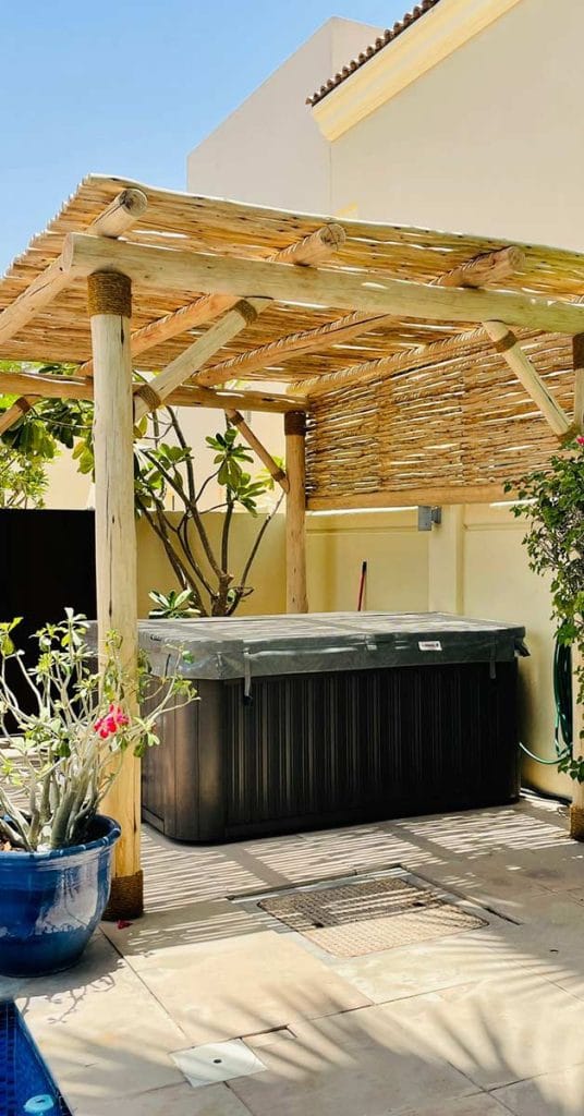 Timber pergola covering an outdoor jacuzzi in Dubai.
