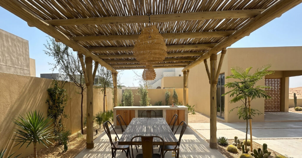 Eucalyptus timber pergola over outdoor lounge and dining area at private residence, Abu Dhabi