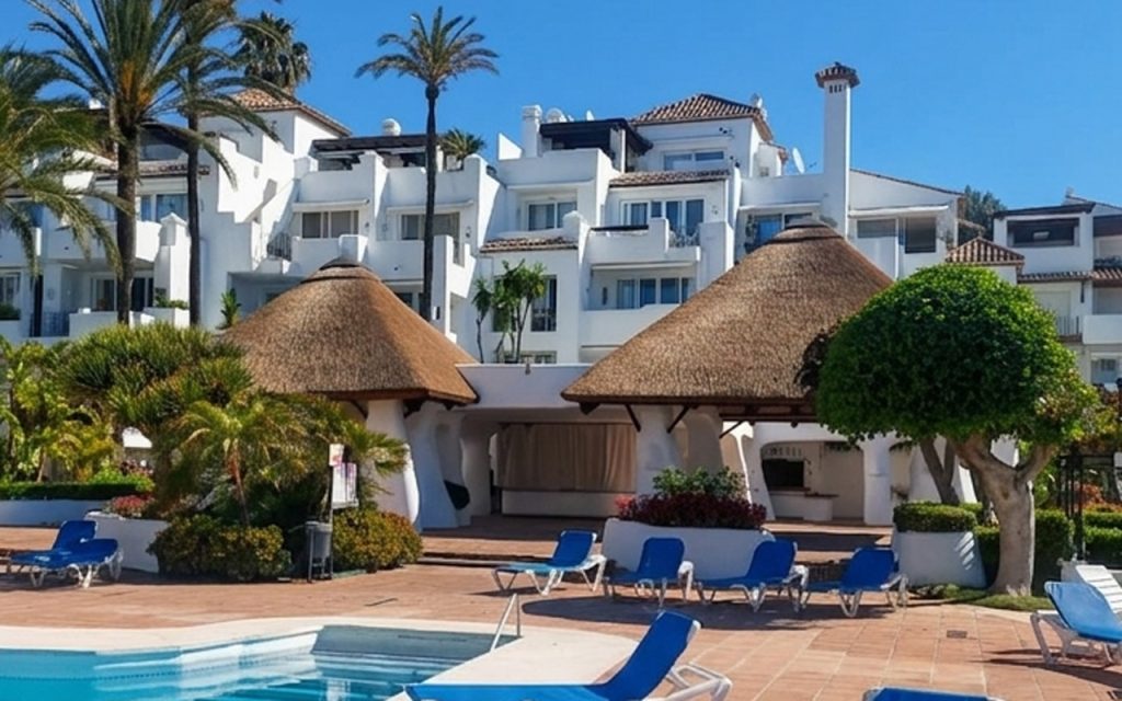 Twin thatched poolside cabanas at Alcazaba Beach Estepona refurbished by Cape Reed International Spain